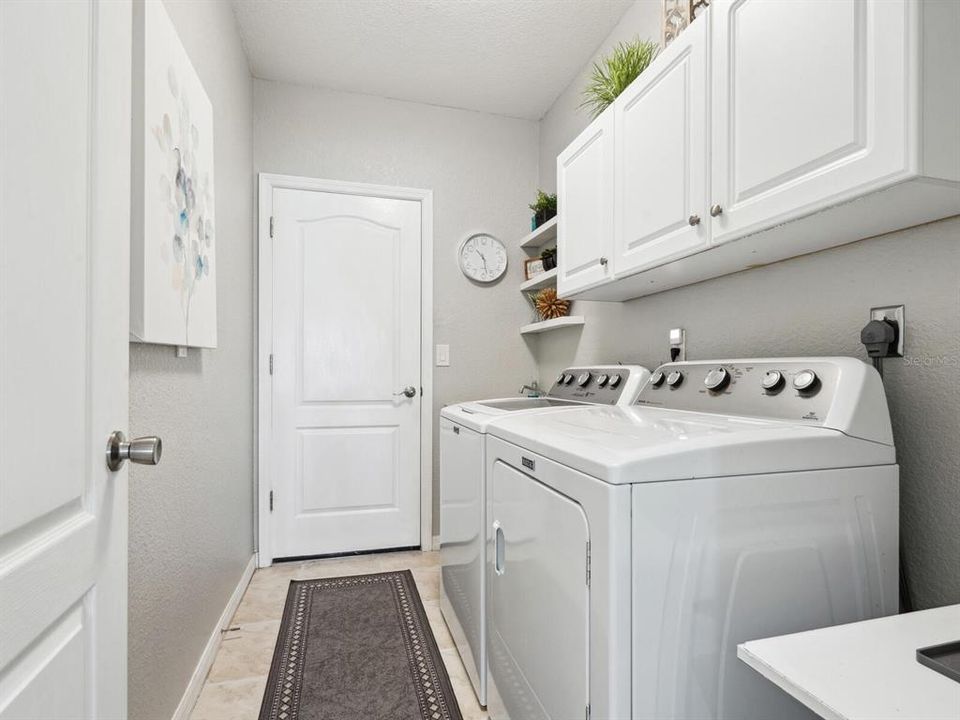 Laundry room with sink and cabinets