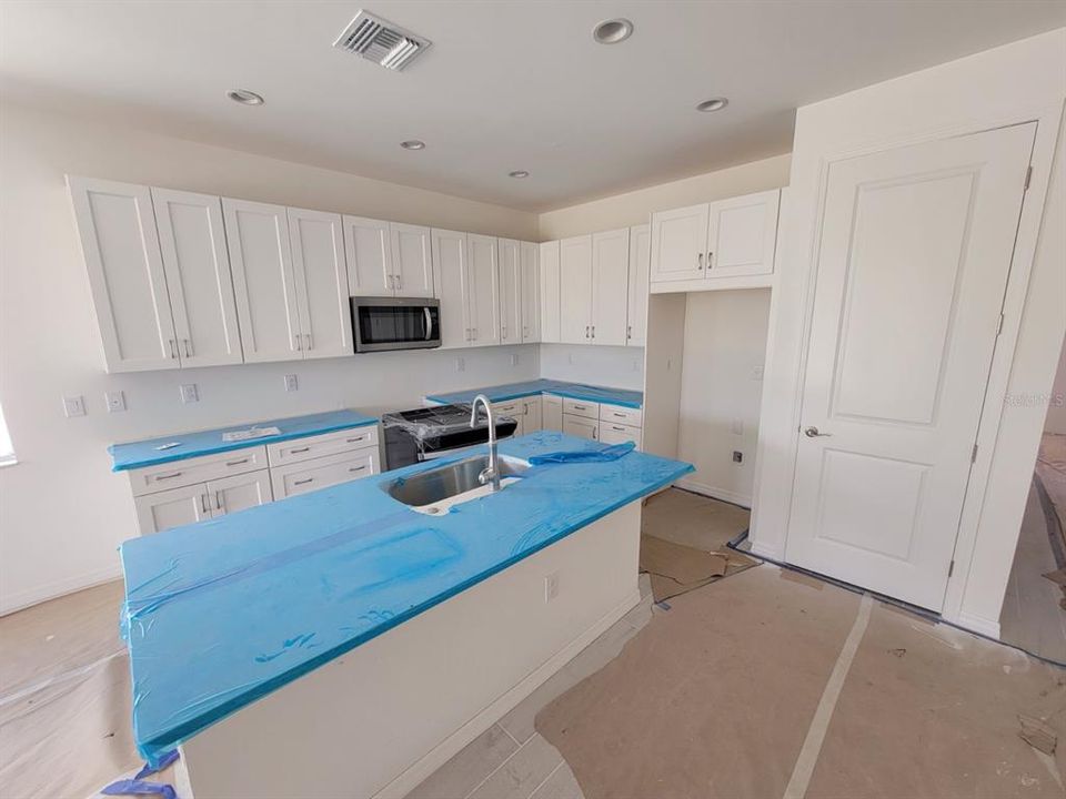 Kitchen with upgraded soft-close cabinets and drawers and lovely white quartz countertops