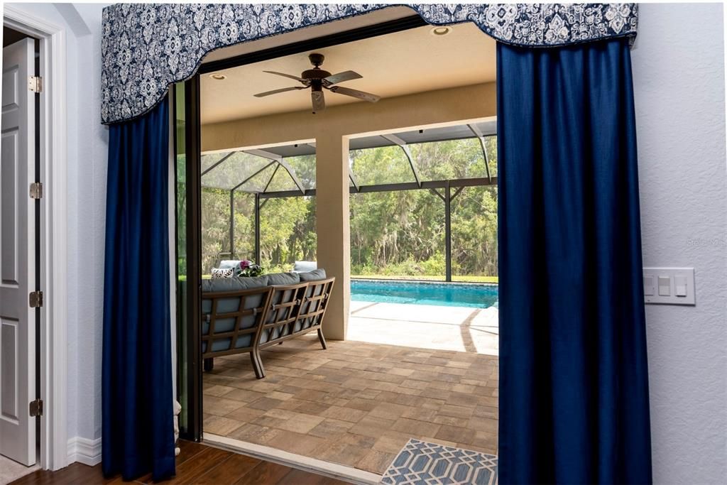 The pocketed double slider in the living room opens to the spectacular pool area.