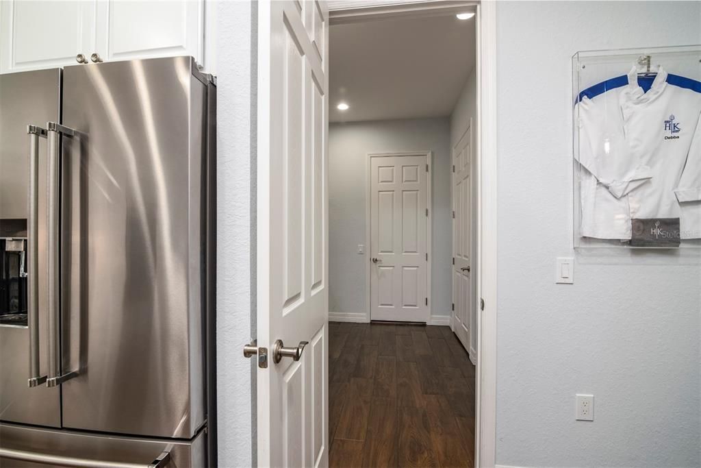 This doorway in the kitchen leads to the flex room and subsequently to the attached 2 car and golf cart garage.