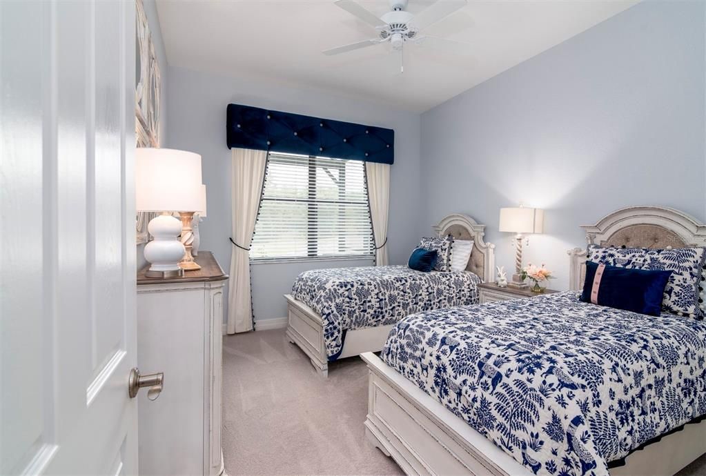 The second bedroom is at the rear of the home and has a ceiling fan, quality carpeting, and a large reach-in closet.