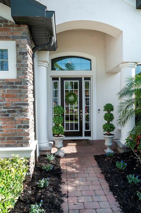The vaulted front entry leads to the paned front door and sidelights. The over the transom window is great for natural light.