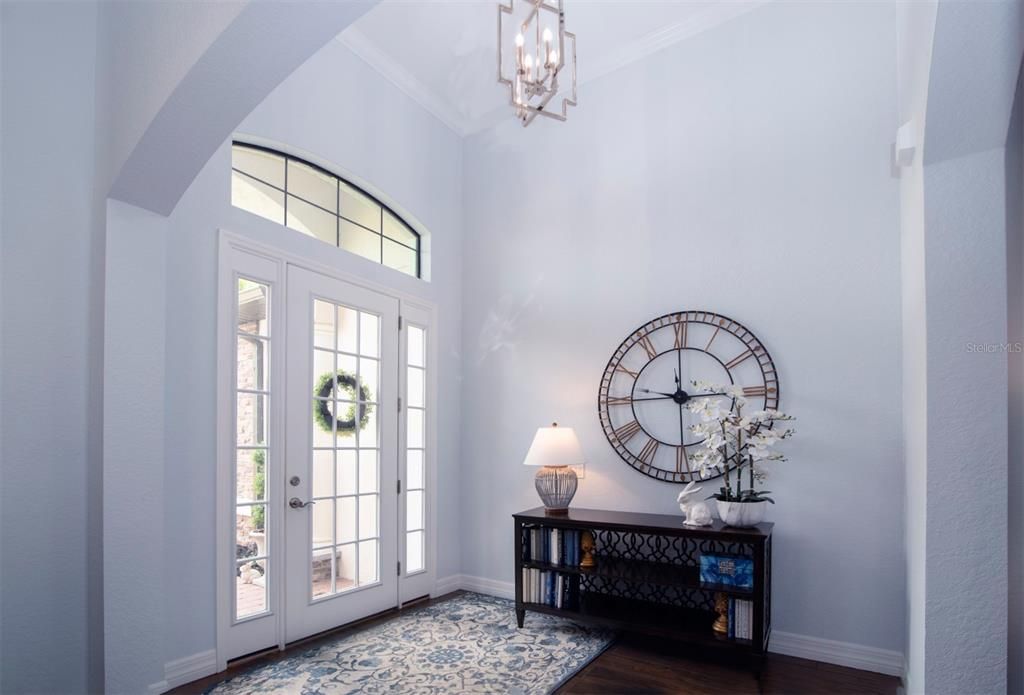 The foyer with its vaulted ceiling is defined by graceful arches and pillars.