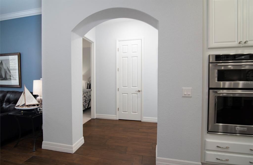 This graceful arch leads to the guest wing with its 2 bedrooms, linen closet, and guest bath.
