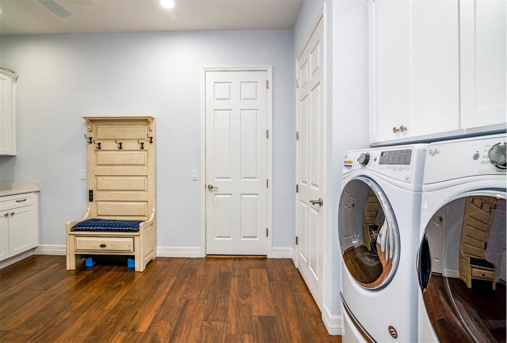the flex room has the laundry area and additional cabinetry. The door straight ahead opens to the attached garage.