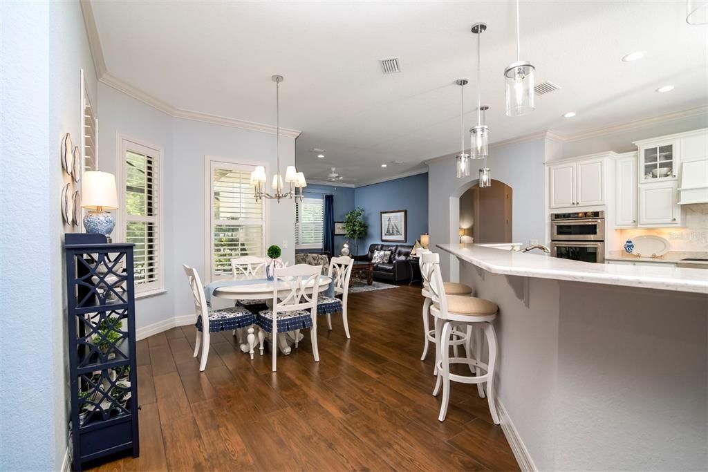 The breakfast nook is in a bay window area adjacent to the kitchen and has a great view of the pool, pond, and preserve.