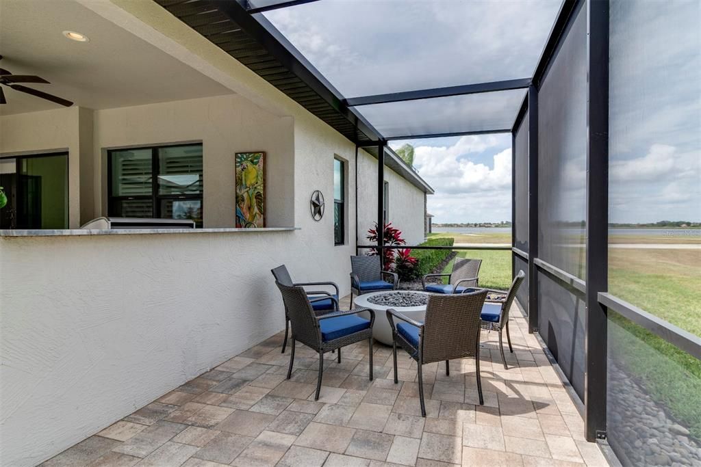The wrap around segment of the birdcage has a propane firepit which can be enjoyed while looking at the golf course and lake across the street.