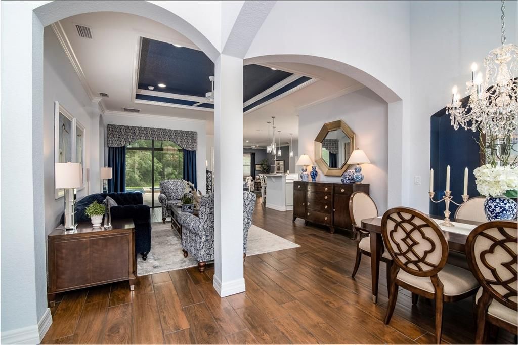 The vaulted foyer and dining area are defined by graceful arches and pillars.