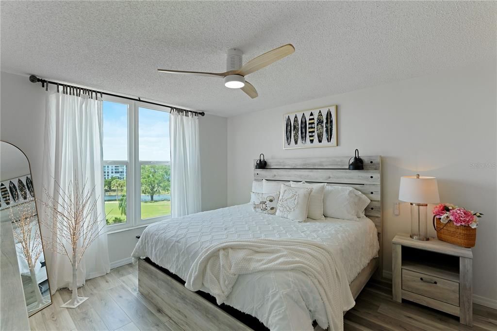 Spacious light & bright primary bedroom overlooking the golf course & door out to lanai