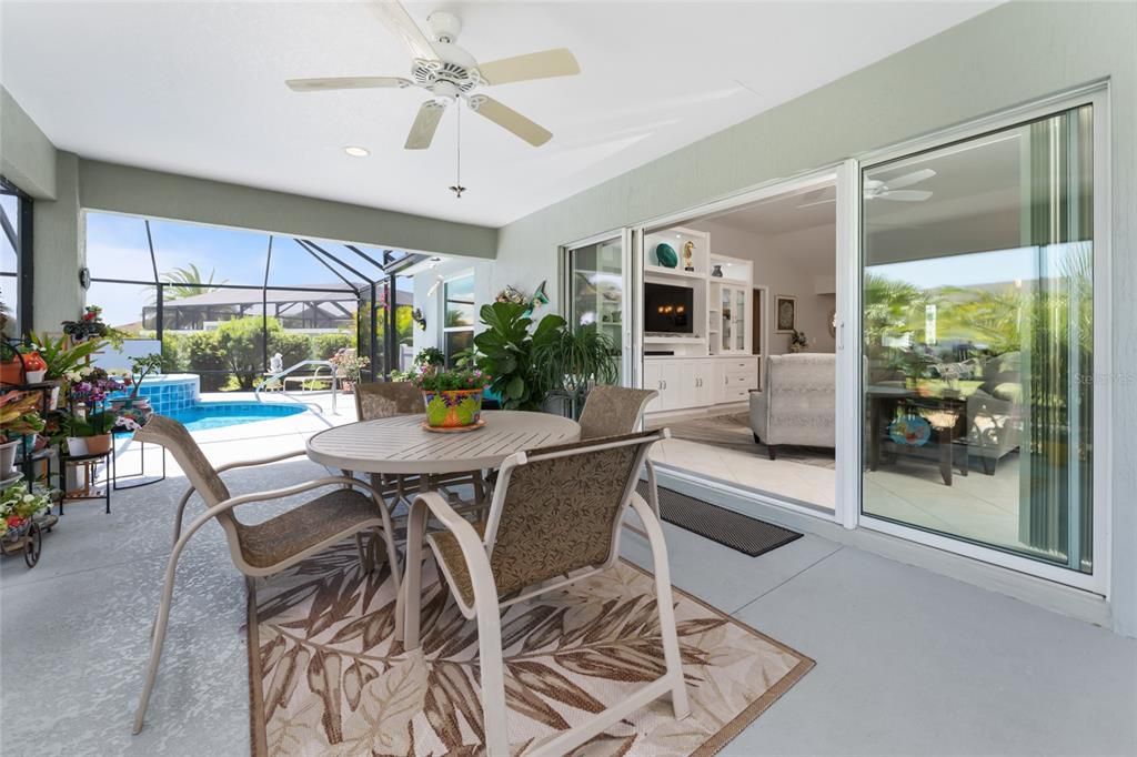 SCREEN ENCLOSED LANAI view shows STACK BACK SLIDING GLASS DOORS leading to the LIVING ROOM.