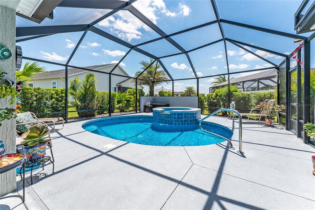 POOL & SPA features a 1535 sf area under the MANSARD SCREENED POOL ENCLOSURE. Now this is a spacious  yet cozy outdoor living haven!