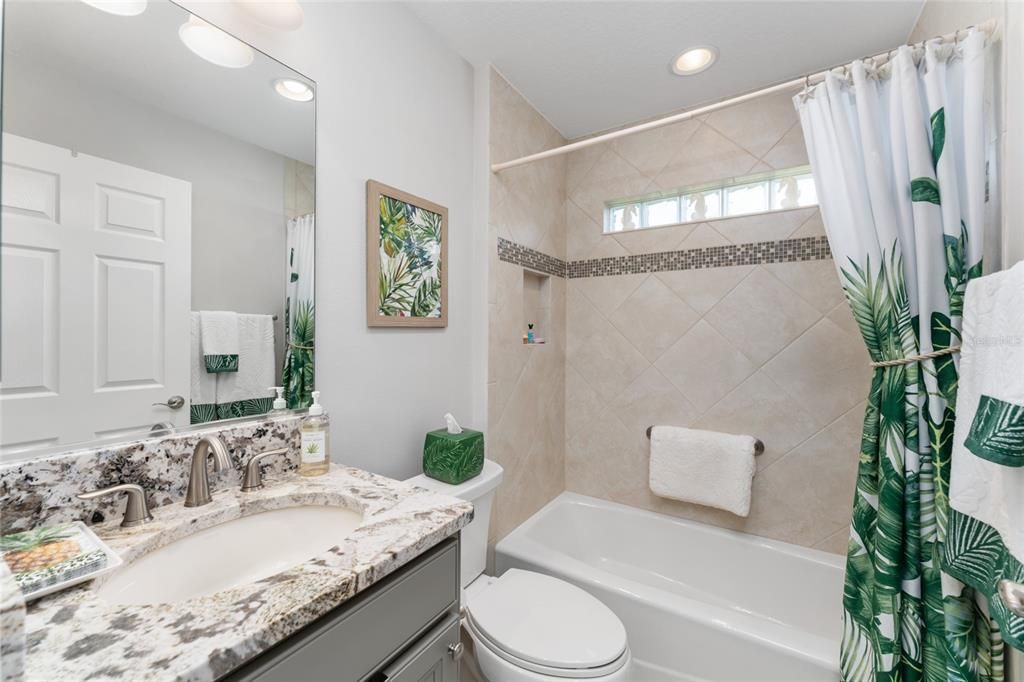 BATHROOM #2 has matching exotic GRANITE COUNTERS, COMFORT HEIGHT TOILET, & TUB/SHOWER combo w/ TILE SURROUND