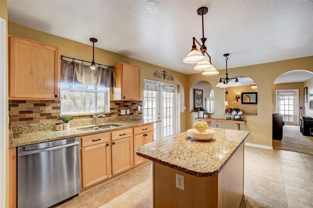 Stainless steel appliances, granite counters & views of the backyard!
