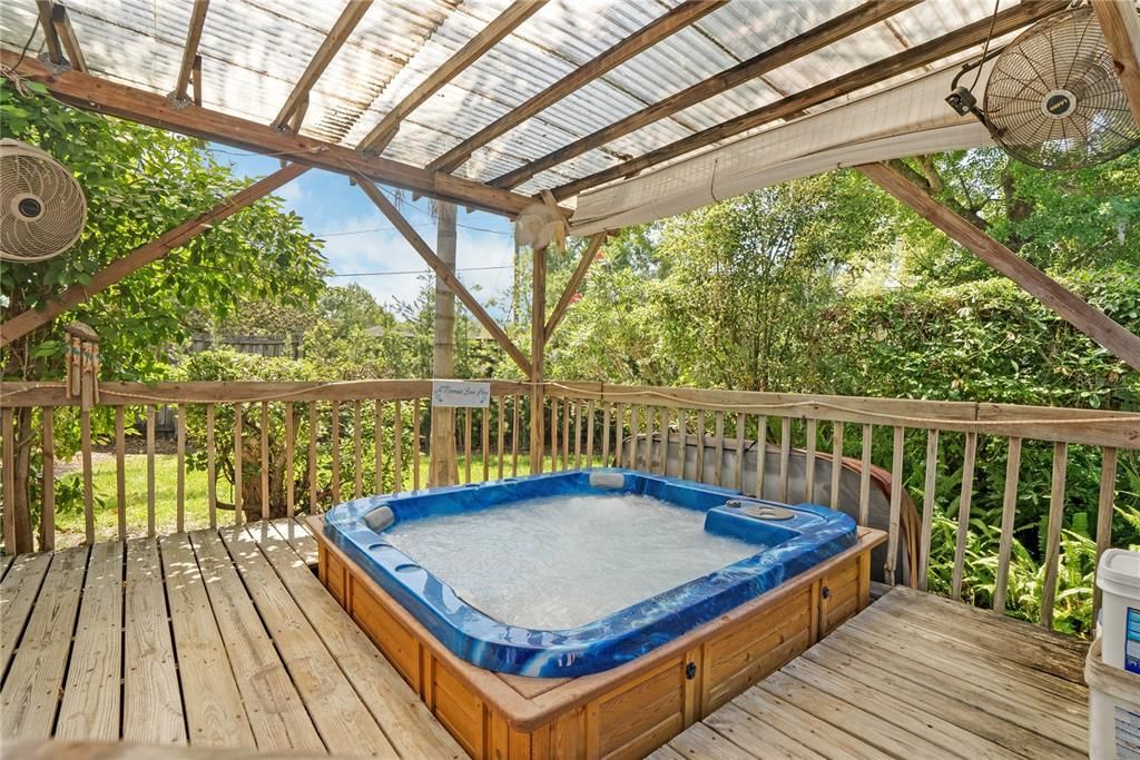Hot tub on deck with deck and railing  fenced in