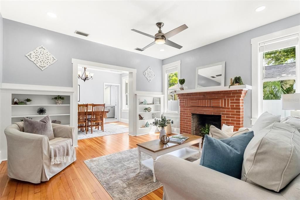 Living room is spacious, with a beautiful brick wood-burning fireplace.  Ceilings are all 9 ft high, which also add an element of extra volume & space to the home.