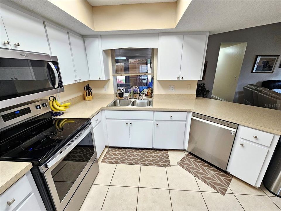 Kitchen with stainless appliances and pass through to the Florida Room