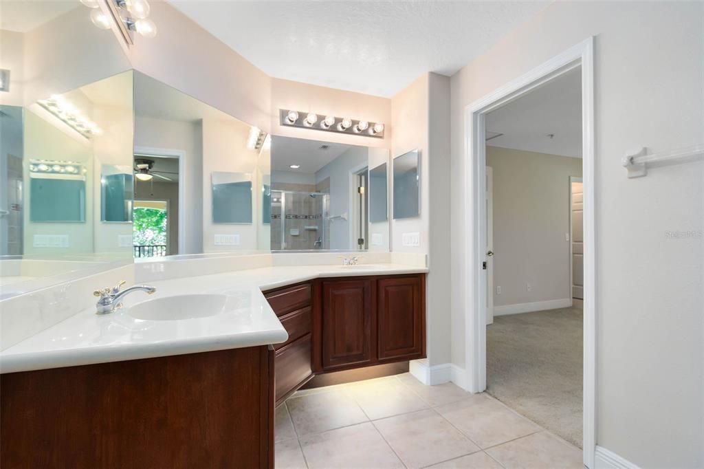 Your primary ensuite bath features dual sinks, ample cabinet space, modern under-cabinet lighting, and a shower.