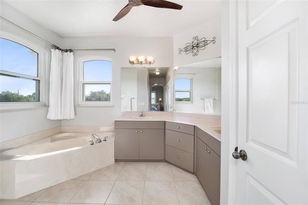 Primary bathroom looking from closet hall.