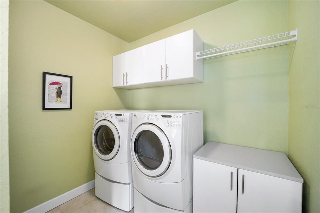 Laundry room with cabinetry.