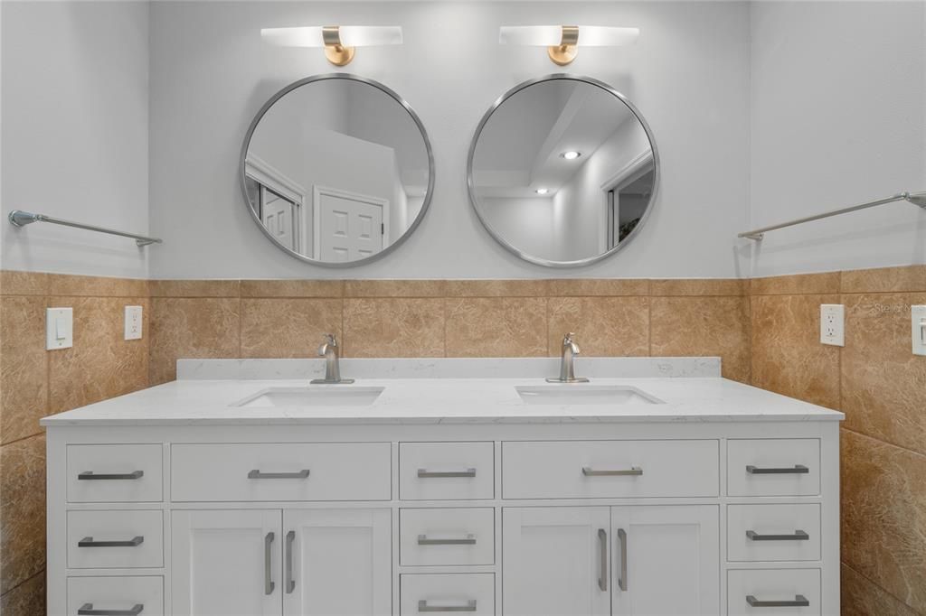 Primary bath with new vanities, mirrors and lighting
