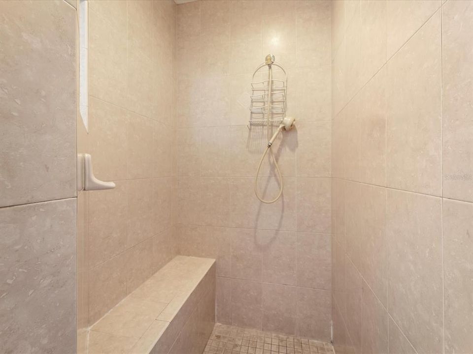 Primary bathroom with walk in shower and bench