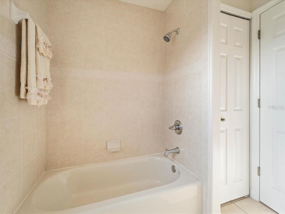 Guest bathroom featuring shower & tub