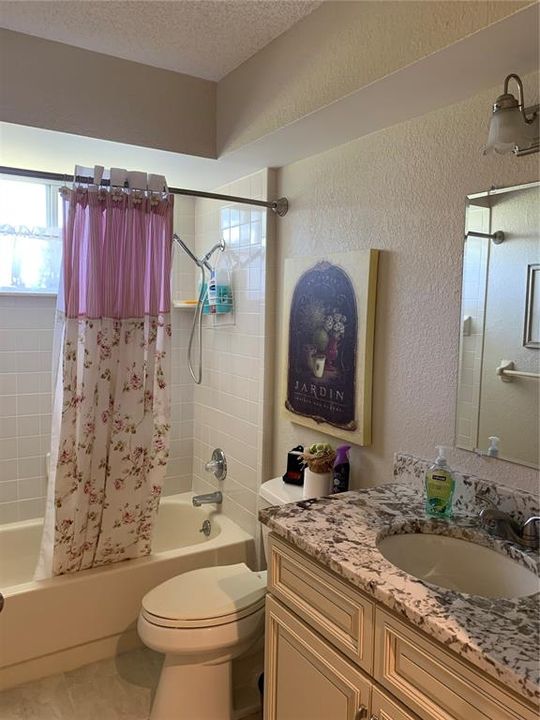 Guest bathroom updated counter, cabinet, lights, faucet, porcelain tile floors