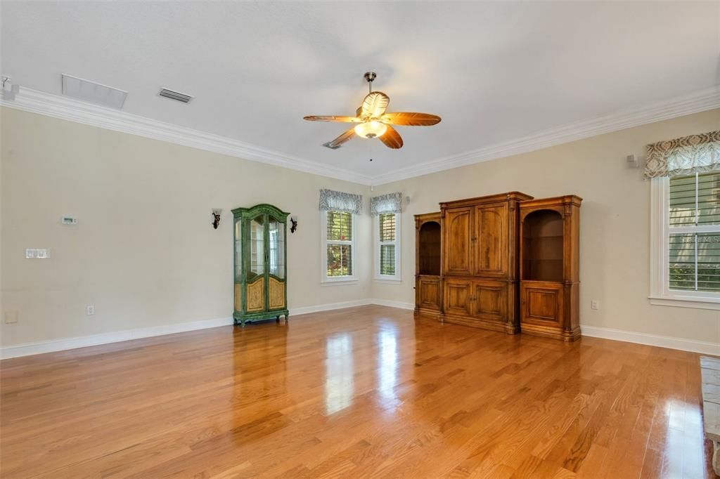 The family room is very large has a wood burning fireplace, built in shelving along with french door to the lanai .