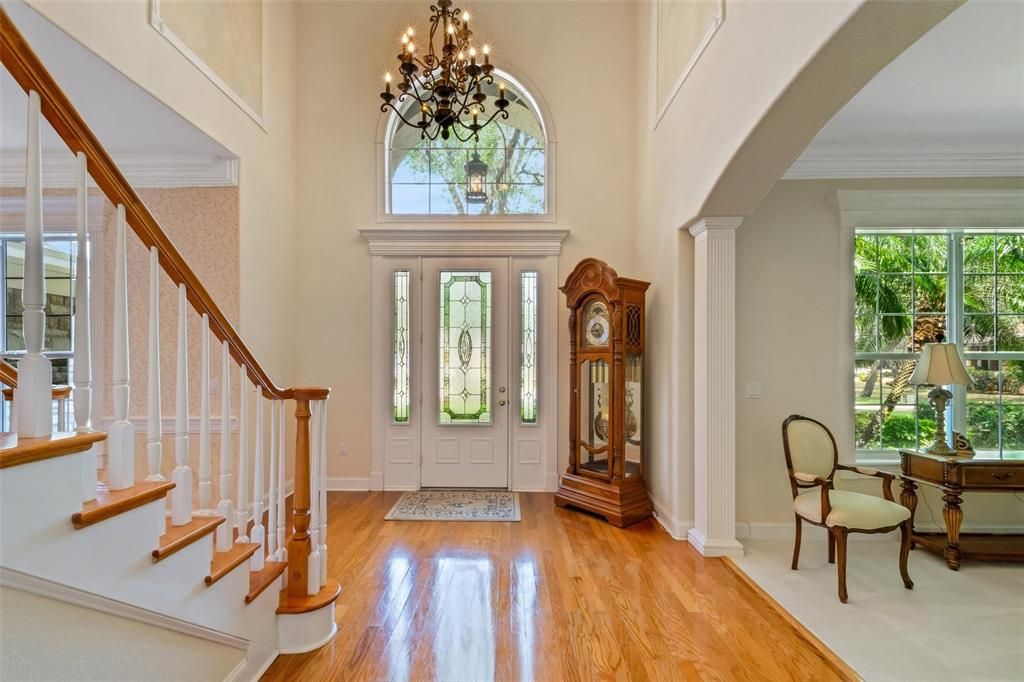 The foyer features soaring ceilings, gleaming hardwood floors and the staircase to the second floor