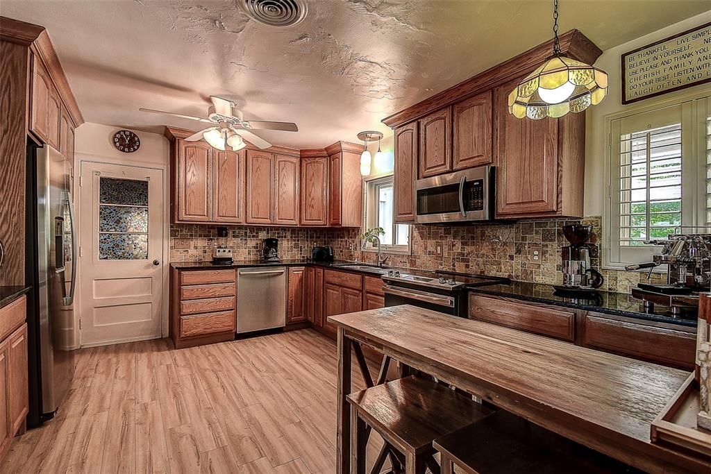 Wood cabinetry and stainless appliances in kitchen.