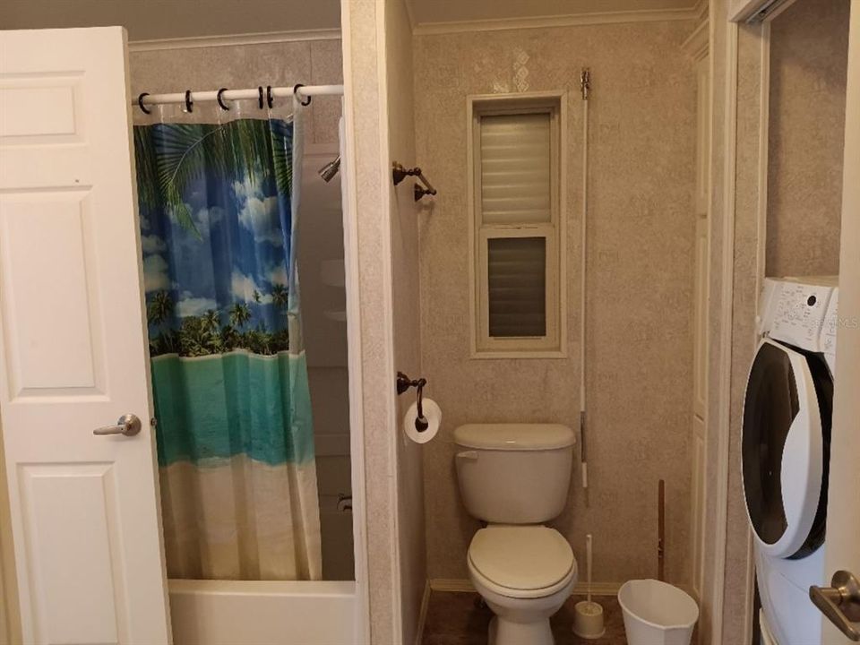 NOW WE ARE LOOKING AT THE MULTI USE GUEST BATHROOM.  WASHER AND DRYER ARE CONVENIENTLY HOUSED HERE AND THE DOOR ALLOWS THE SECOND BEDROOM TO HAVE TO USE THIS CONVENIENT BATHROOM.