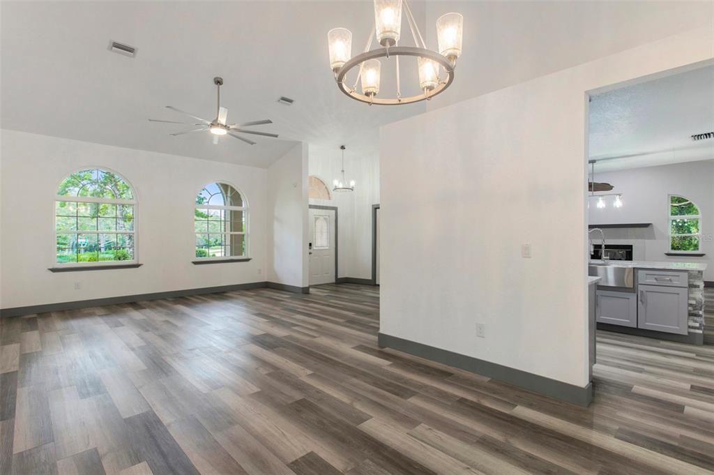 Step inside to a light-filled, inviting open space. Arched windows and modern touches create a welcoming atmosphere, while sliding glass doors seamlessly connect you to the inviting poolside haven