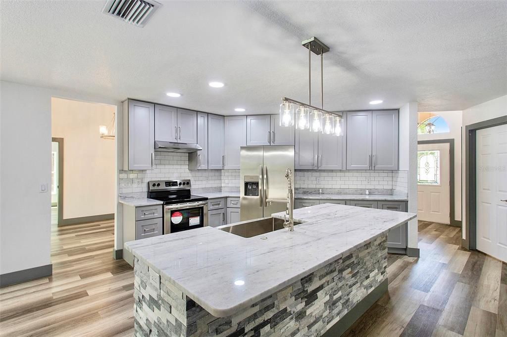 This completely renovated space boasts brand new stainless steel appliances, elegant backsplash, gleaming granite countertops, and plenty of pantry space!