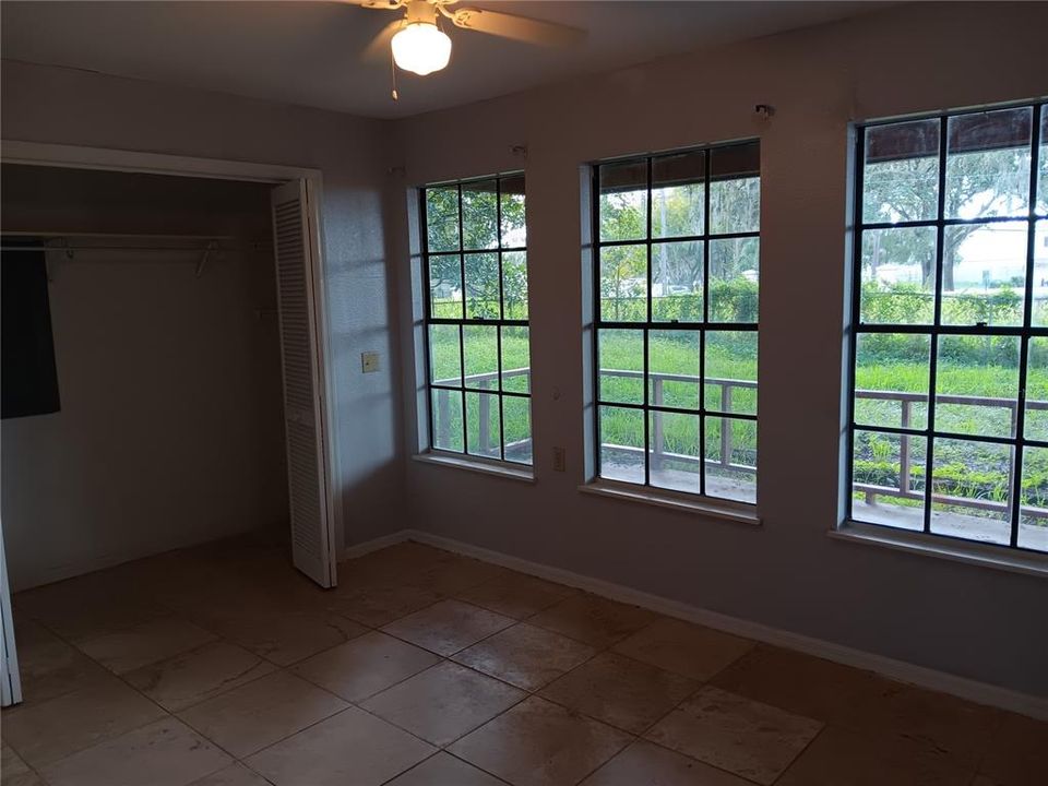 2nd bedroom with expensive travertine flooring