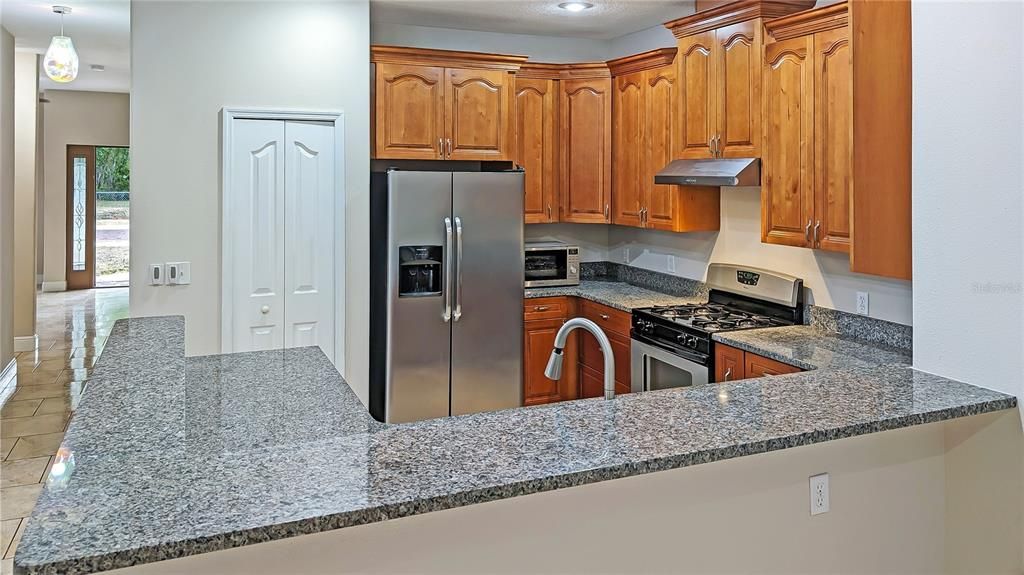Kitchen! All GRANITE COUNTER TOPS and a Gorgeous Kitchen with Breakfast Bar Seating… and 42” Quality Cabinetry with Crown Molding!