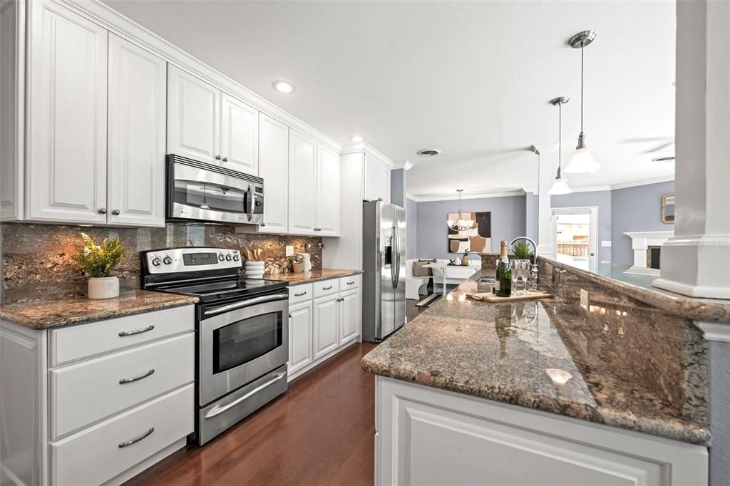 Kitchen with lots of white cabinetry & granite counters