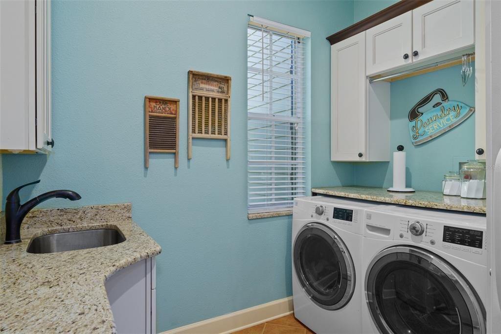 Laundry area with extra cabinetry and space to fold clothes.