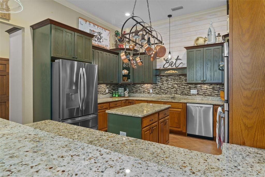 Kitchen with granite counters, tons of cabinets.