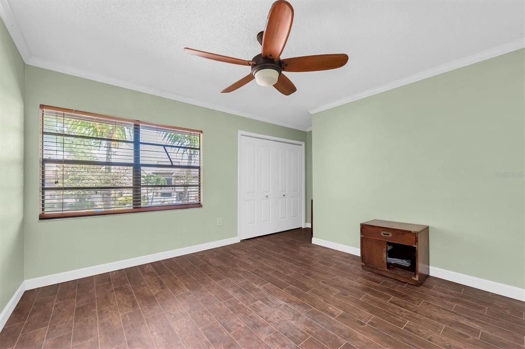 this is the front bedroom on the second floor, the one with the tiny little peek-a-boo glimpse of the lake between two palms and two buildings