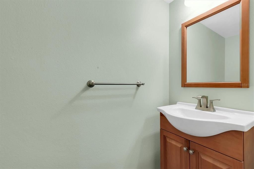 downstairs half bath; ceramic plank tiles in here as well as all through the downstairs common area