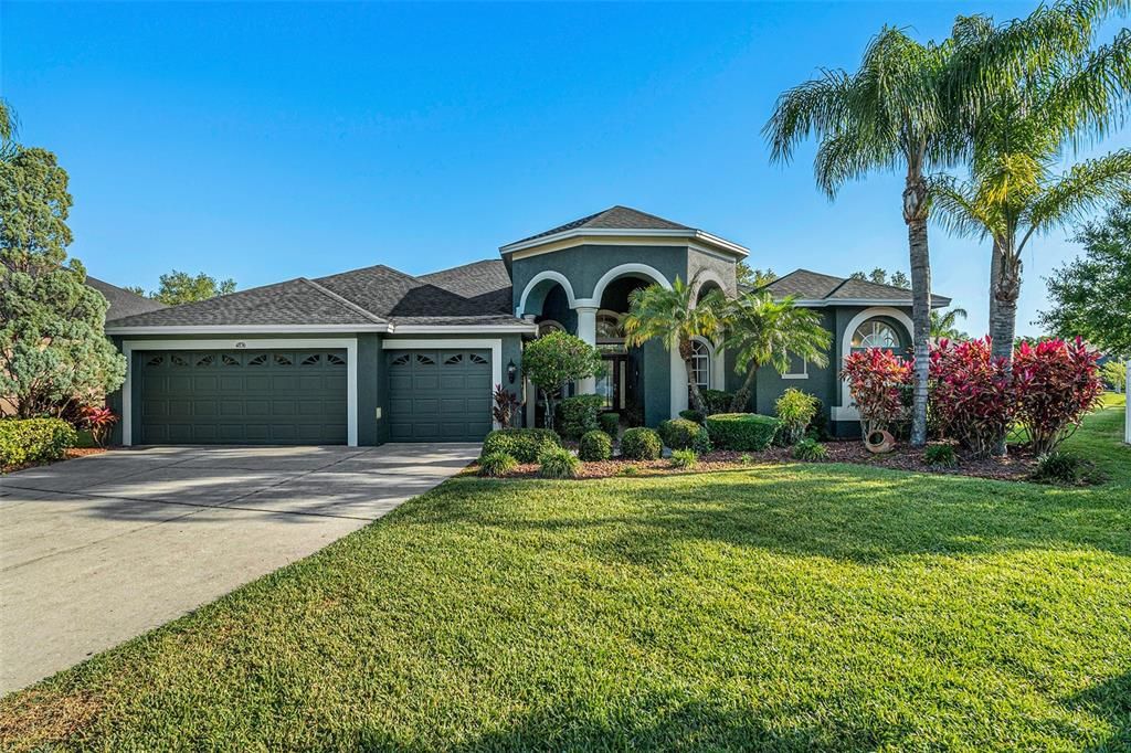 Front. One of a kind home with a beautiful partial pond view! Desirable GATED Lake Talia!