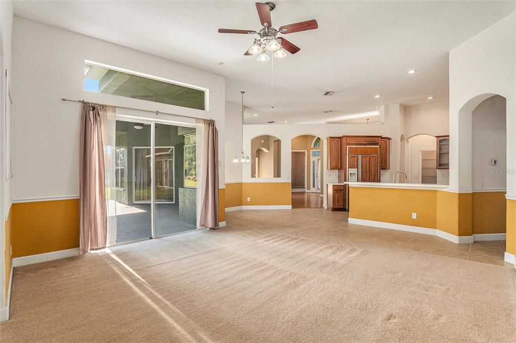 The family room is bathed in natural light. Sliding doors to the outdoor area, making it perfect for entertaining and family gatherings.