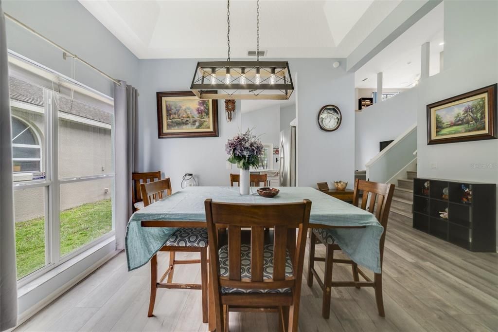 The formal dining room is the perfect gathering space to host family and friends with easy access to the kitchen and a natural flow into the spacious living area.