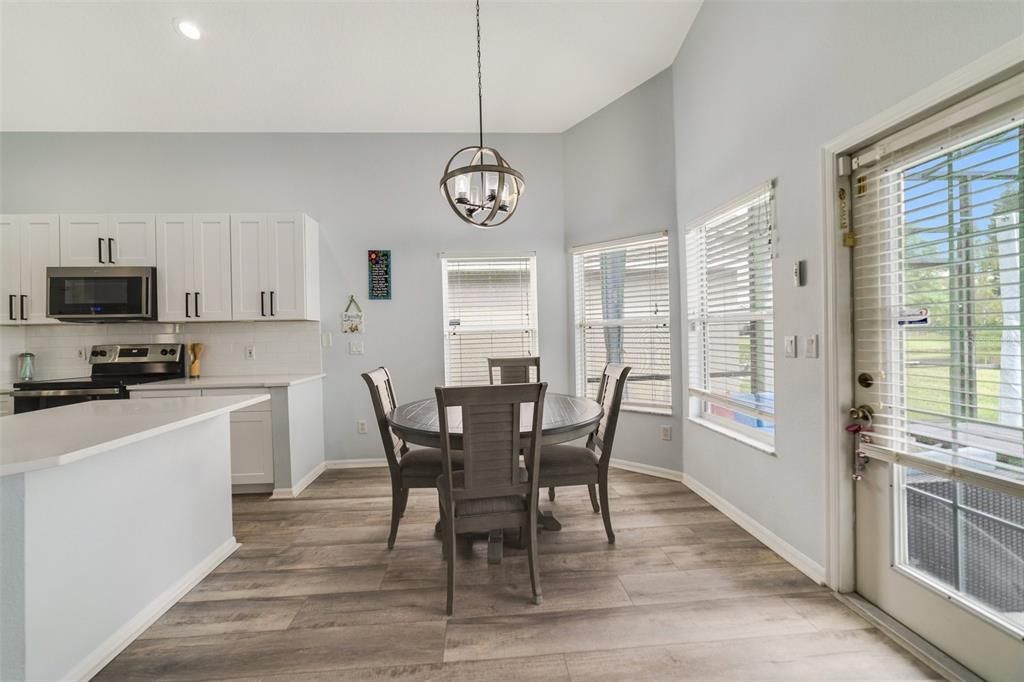 A casual dining space overlooks the pool and pond and is the perfect transition into the family room where the two story ceiling is open to the loft above!