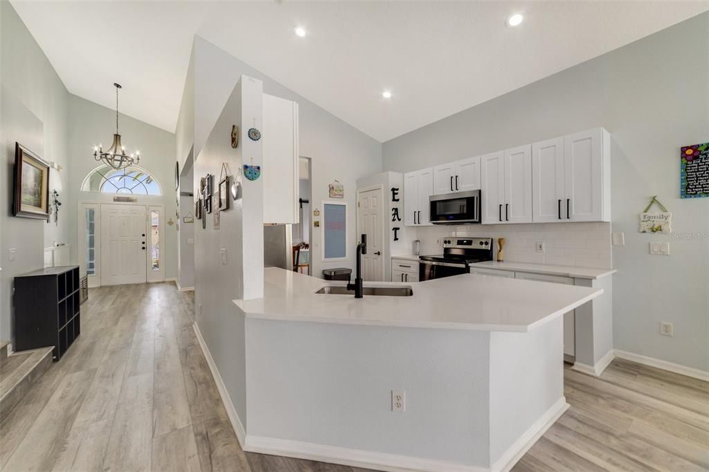 This bright OPEN CONCEPT floor plan is highlighted by the soaring ceilings and the NEWER ROOF, UPDATED A/C, NEW FLOORING & FIXTURES THROUGHOUT, RENOVATED KITCHEN, FRESH PAINT and POOL REFINISHES are just the beginning!