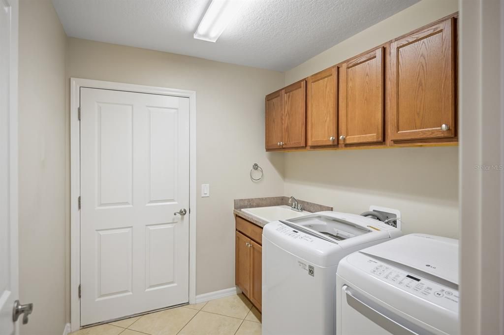 Laundry with washer dryer and tub sink
