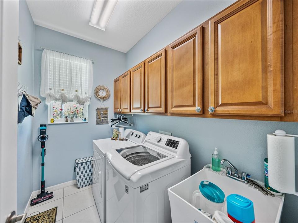Inside laundry room with storage & utility sink