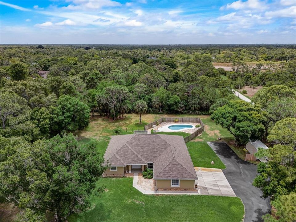 Over 2 ACRES for your own personal paradise just minutes from the Indian River and shores of the Atlantic surrounded by beautiful mature trees with a 3BD/2BA POOL HOME featuring a NEW ROOF (2023), NEW WATER SOFTENER SYSTEM, NEW WELL and a workshop complete with electricity!