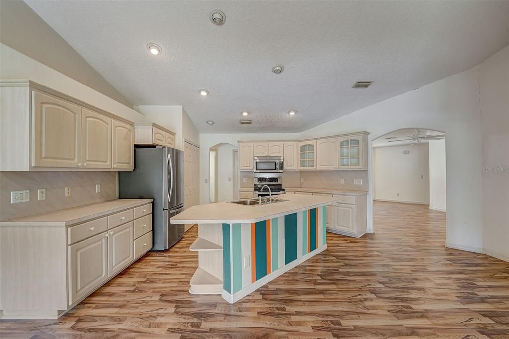 The family chef will appreciate the spacious kitchen offering STAINLESS STEEL APPLIANCES, ample storage and the large ISLAND gives you additional prep/storage space as well as a breakfast bar for casual dining with family or entertaining friends.