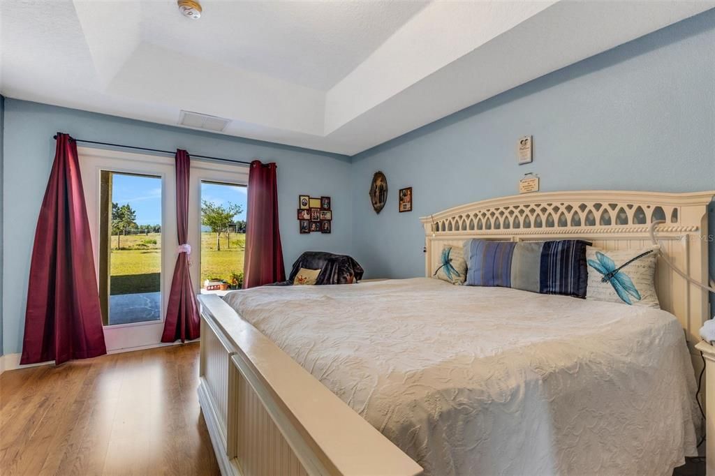 Primary bedroom has French doors leading to the back patio